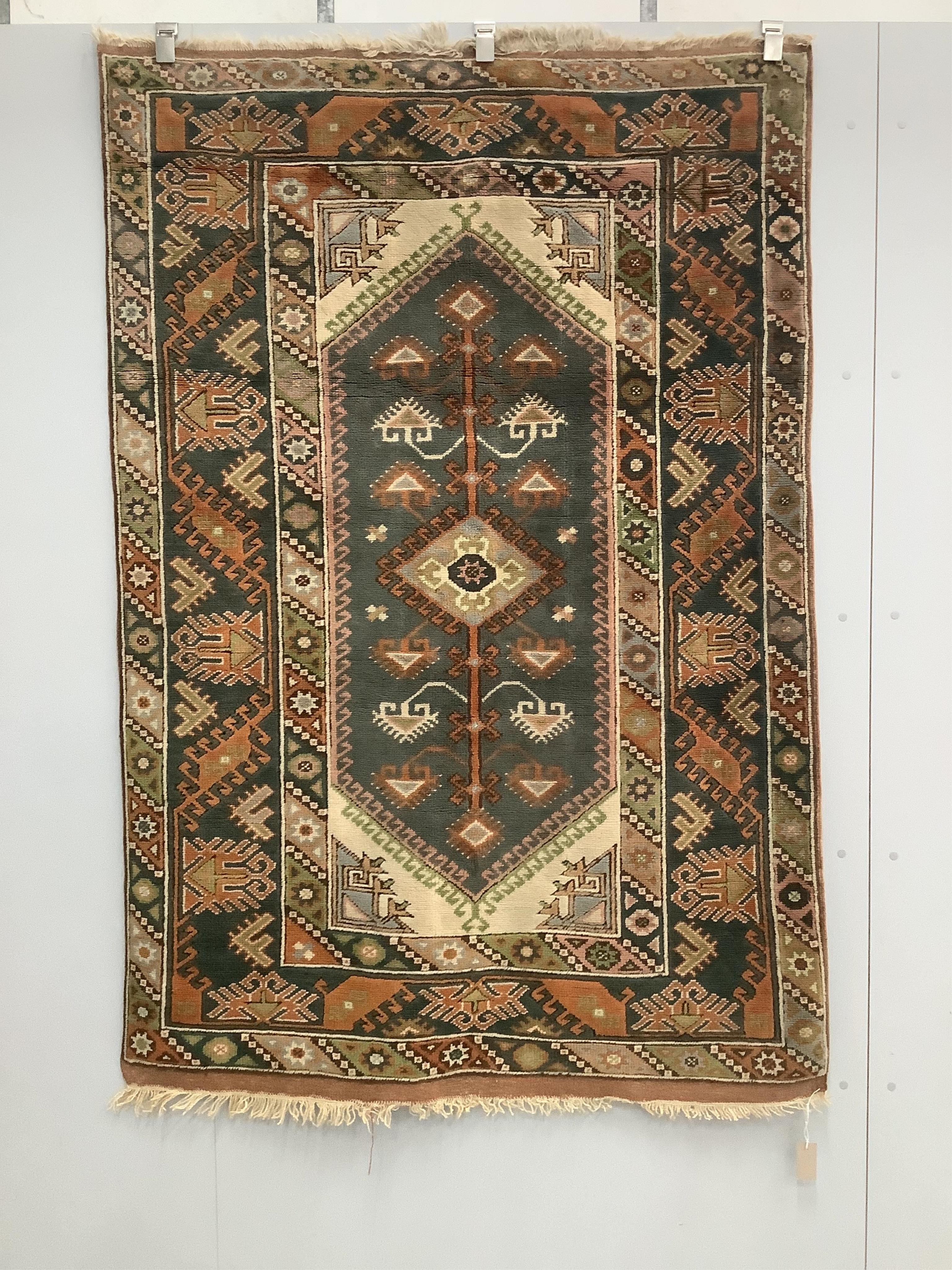 A Caucasian style multicoloured geometric rug, 190 x 130cm. Condition - fair